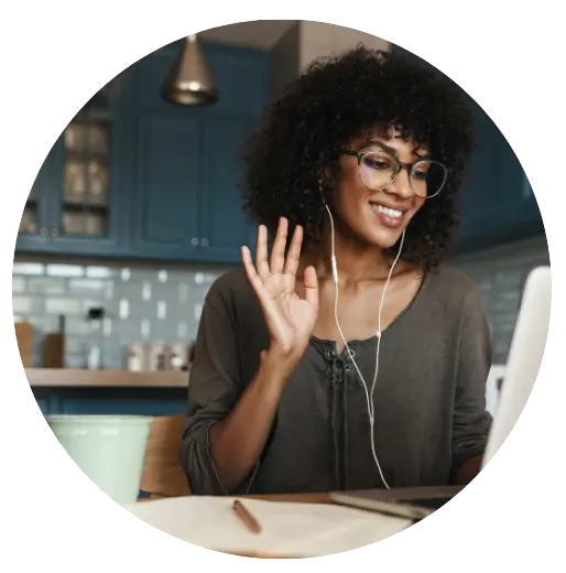 Online mulher negra fazendo uma reunião online sentada na mesa de uma cozinha